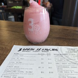 a pink smoothie with a red straw