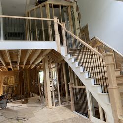Novak and Sons Construction - Oak handrails with poplar skirt boards.