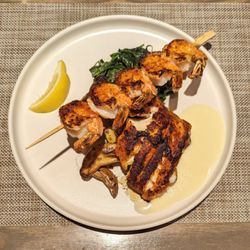 Coast Seafood Grill - Blackened Tripletail with a side of blackened grilled shrimp. Also, fingerling potatoes and wilted garlic spinach.