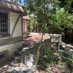 Rear of Marjorie Stoneman Douglas's house showing the 'solution hole' at the rear corner of the property, that helped keep it cool.