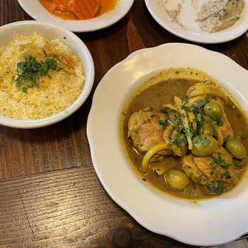 Cafe Mogador - Chicken Moroccan Tagine with Preserved Lemons and olives with a side of couscous - Moroccan Near Me - Brooklyn, New York Cafe Mogador - Chicken Moroccan Tagine with Preserved Lemons and olives with a side of couscous - Moroccan Near Me - Brooklyn, New York
