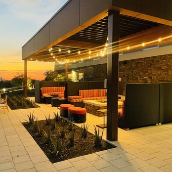 Home2 Suites by Hilton Mesa Longbow - Balcony and patio area with bbq, pool and views of the golf course. - Hotels Near Me - Mesa, Arizona Home2 Suites by Hilton Mesa Longbow - Balcony and patio area with bbq, pool and views of the golf course. - Hotels Near Me - Mesa, Arizona