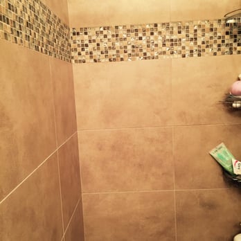Better Builderz - a bathroom with a tiled shower - Flooring Near Me Better Builderz - a bathroom with a tiled shower - Flooring Near Me