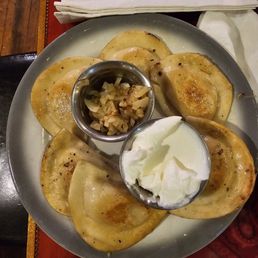Pierogis with sautéed onions and sour cream. Pierogis with sautéed onions and sour cream.