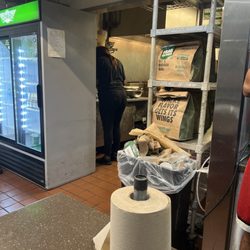 Wingstop - Dirty kitchen floors overflowing trash
