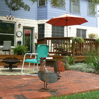 Perfect Lawns & Landworks - a patio with chairs and an umbrella - Landscaping Near Me - Austin, Texas Perfect Lawns & Landworks - a patio with chairs and an umbrella - Landscaping Near Me - Austin, Texas