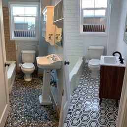 a bathroom with a sink, toilet, and bathtub