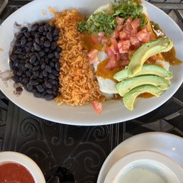 Chicken enchiladas with beans, rice, and avocado Chicken enchiladas with beans, rice, and avocado