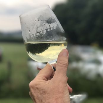 Bluestone Vineyard - a hand holding a glass of white wine - Wineries Near Me - Bridgewater, Virginia Bluestone Vineyard - a hand holding a glass of white wine - Wineries Near Me - Bridgewater, Virginia