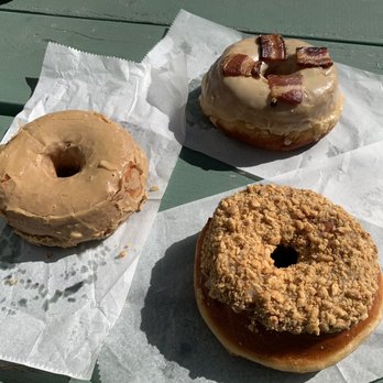 Union Square Donuts - Clockwise starting from the left: Vietnamese iced coffee, maple bacon, hazelnut chocolate crunch donuts - Donuts Near Me - Boston, Massachusetts