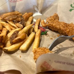 a basket of fried fish and fries