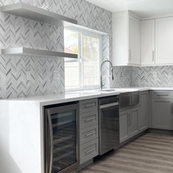 AMI Design & Associates - Add drama to your Kitchen Remodel with a Quartz Waterfall Counter and take the Back Splash to the ceiling!
