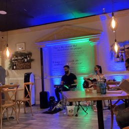 a group of people sitting at tables in a restaurant