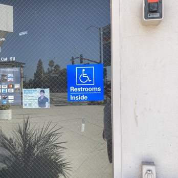 Chevron - the reflection of a parking sign in a window - Gas Stations Near Me - Arcadia, California