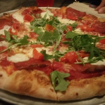 Pinthouse Pizza - Ooh La La "Red sauce, house cheese blend, fresh mozzarella, pepperoni, baby arugula, spicy local honey, and  peppadew peppers," - Pizza Near Me - Austin, Texas