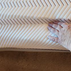 Behind my thumb is the upper layers of the mattress, my palm is just setting on the lower layers