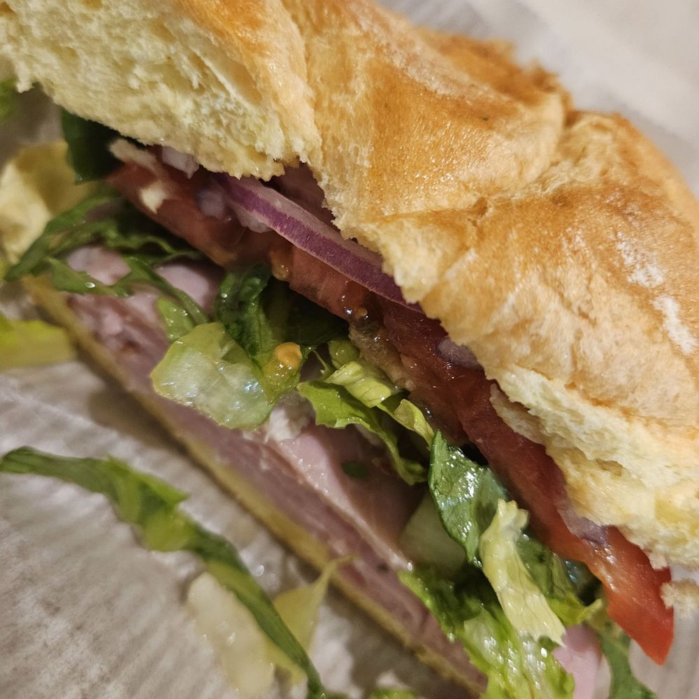 a sandwich with lettuce, tomatoes, and meat a sandwich with lettuce, tomatoes, and meat