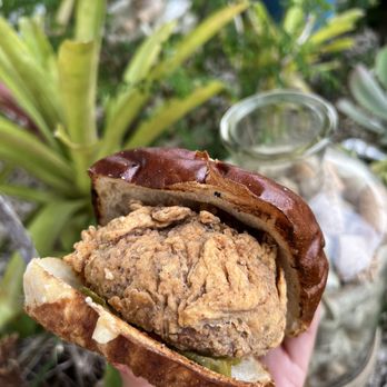 Swirlery - a hand holding a sandwich - Wine Bars Near Me - Orlando, Florida