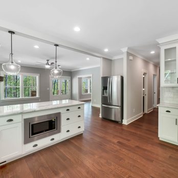 Cole Construction - a kitchen with white cabinets and wood floors - General Contractors Near Me - Chattanooga, Tennessee