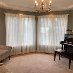 Pugerudes - Pinch pleat sheer on wood pole with rings.