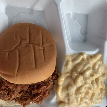Rolling Smoke Wings & More - a pulled pork sandwich with macaroni and cheese - Food Trucks Near Me