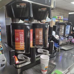 Coffee pots filled with cold coffee and caps on the spigots