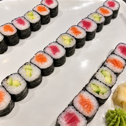 Umami - A beautifully arranged sashimi platter featuring fresh seafood, colorful garnishes, wasabi, and pickled ginger.