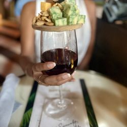 The Wilder - Happy hour wine with charcuterie board topper for five dollars