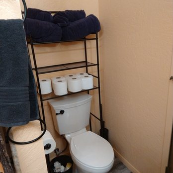 IP Universal Construction - a bathroom with a toilet and towel rack - Painters Near Me