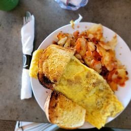 This is a 3 egg Irish omelet, homemade corned beef, sourdough and potatoes.