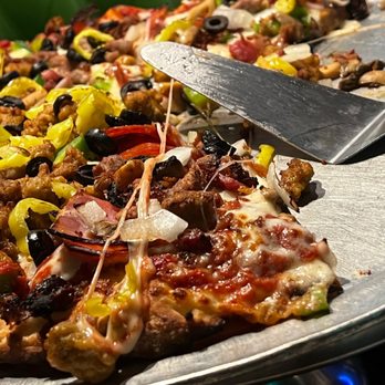 Green Lantern Pizza - a pizza with olives and other toppings - Pizza Near Me - Royal Oak, Michigan