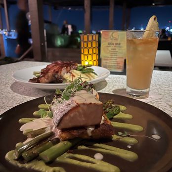 C Level - Pan Roasted Salmon (front), Steak Frites (back), and Mai Tai. - New American Near Me - San Diego, California C Level - Pan Roasted Salmon (front), Steak Frites (back), and Mai Tai. - New American Near Me - San Diego, California