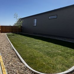 Ace Of All Trades - Installed rock landscaping curbing and sod.