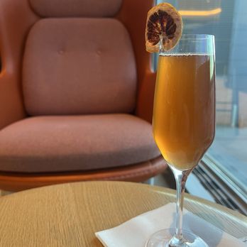 Etihad Lounge - Cherry blossom inspired cocktail (gin, cherry liqueur, lemon juice, simple syrup, topped with cava) - Airport Lounges Near Me - Dulles, Virginia Etihad Lounge - Cherry blossom inspired cocktail (gin, cherry liqueur, lemon juice, simple syrup, topped with cava) - Airport Lounges Near Me - Dulles, Virginia
