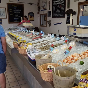 Dockside North Seafood Market - a man standing in front of the counter - Seafood Markets Near Me - Corolla, North Carolina Dockside North Seafood Market - a man standing in front of the counter - Seafood Markets Near Me - Corolla, North Carolina