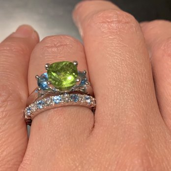 General Diamonds - Engagement ring: Peridot center stone w/ blue topaz accent stones. Wedding band: Eternity band w/ diamonds and blue topaz. - Jewelry Near Me - Los Angeles, California General Diamonds - Engagement ring: Peridot center stone w/ blue topaz accent stones. Wedding band: Eternity band w/ diamonds and blue topaz. - Jewelry Near Me - Los Angeles, California