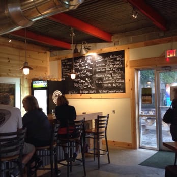Flytrap Brewing - Bar seating and board with brew names - Breweries Near Me - Wilmington, North Carolina Flytrap Brewing - Bar seating and board with brew names - Breweries Near Me - Wilmington, North Carolina