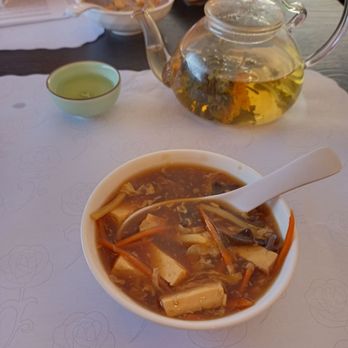 Ming's - Hot and sour soup and a flowering tea ball in a clear tea pot. - Chinese Near Me - Pleasant Hill, California