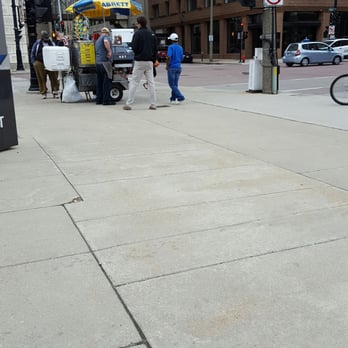 Real Dogs - a man in a blue shirt and a dog on a leash - Hot Dogs Near Me - Milwaukee, Wisconsin