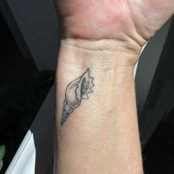 King's Head Tattoo - A Murex shell tattoo, especially when placed delicately on the wrist, holds deep, multifaceted meanings. - Tattoo Near Me - San Diego, California King's Head Tattoo - A Murex shell tattoo, especially when placed delicately on the wrist, holds deep, multifaceted meanings. - Tattoo Near Me - San Diego, California