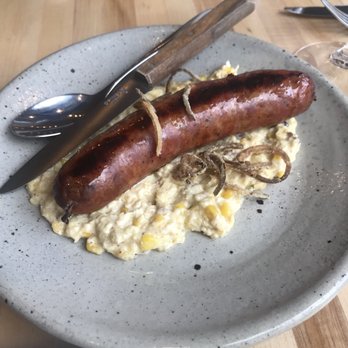 Birch - Chef sausage. Amazing flavor, complements the corn grits. But it was a bit raw inside. - New American Near Me - Milwaukee, Wisconsin