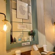 Photo of Brothers & Sisters Co Coffeehouse + Cafe - Brookline, MA, United States. The online order pick up shelf / Dec. 2022