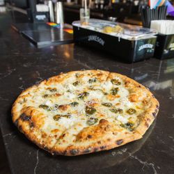 Spicy Cowboy Pizza: Mozzarella, ricotta, candied jalapeños, garlic, garlic butter crust, parmesan