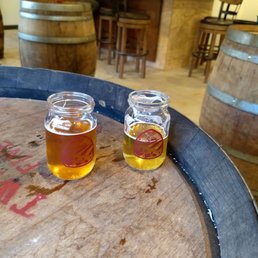 two glasses of beer on a barrel