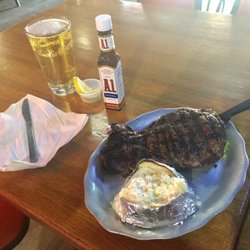 Cedrics - 12oz. Ribeye with a baked potato and a beer.