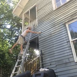 Stringer’s Construction - Painting the side of a house