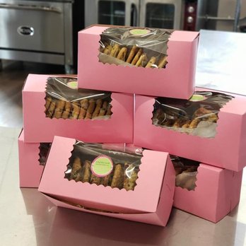Something Sweet - a stack of pink boxes of cookies - Pop-up Shops Near Me Something Sweet - a stack of pink boxes of cookies - Pop-up Shops Near Me