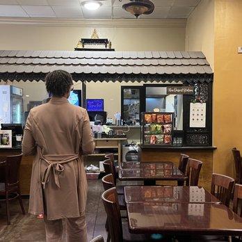 Thai Basil - a woman standing in a restaurant - Thai Near Me - Phoenix, Arizona
