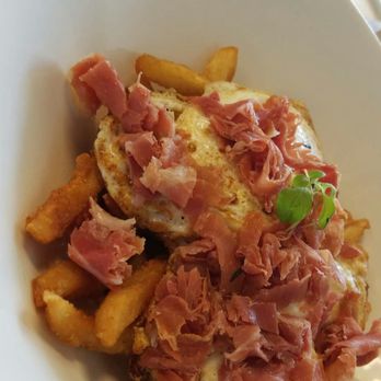 Café Bea - Huevos rotos: truffle oil infused fresh French fries topped with jamón Serrano and huevos fritos. - Cafes Near Me - Miami, Florida Café Bea - Huevos rotos: truffle oil infused fresh French fries topped with jamón Serrano and huevos fritos. - Cafes Near Me - Miami, Florida