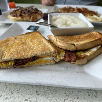 Cracked & Crepe - Bacon egg and cheese sandwich on sourdough bread! Side of creamy grits - Breakfast & Brunch Near Me - Frisco, Texas Cracked & Crepe - Bacon egg and cheese sandwich on sourdough bread! Side of creamy grits - Breakfast & Brunch Near Me - Frisco, Texas